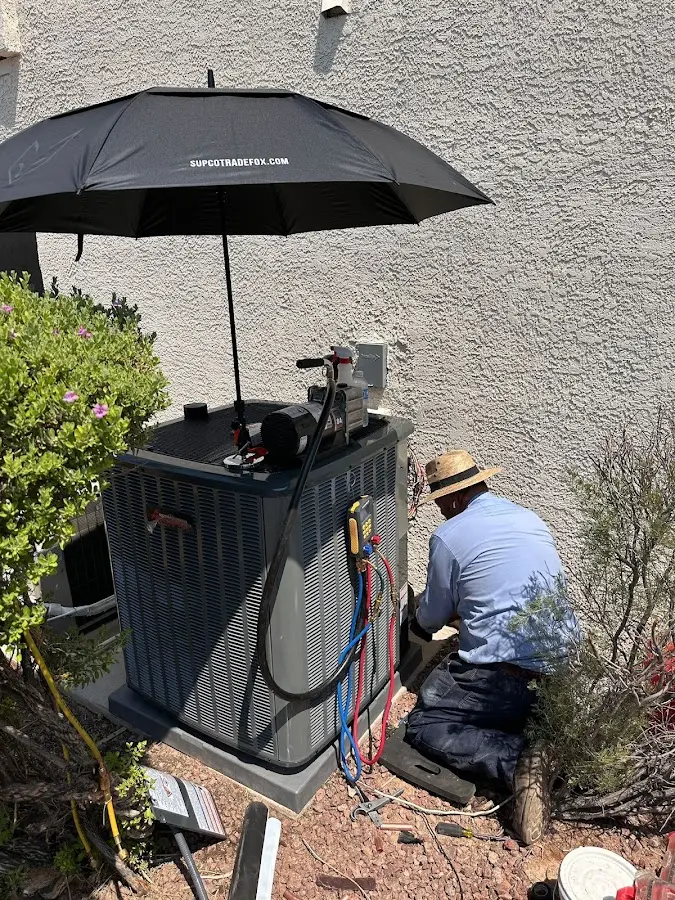 HVAC technician performing outdoor AC maintenance in Corning